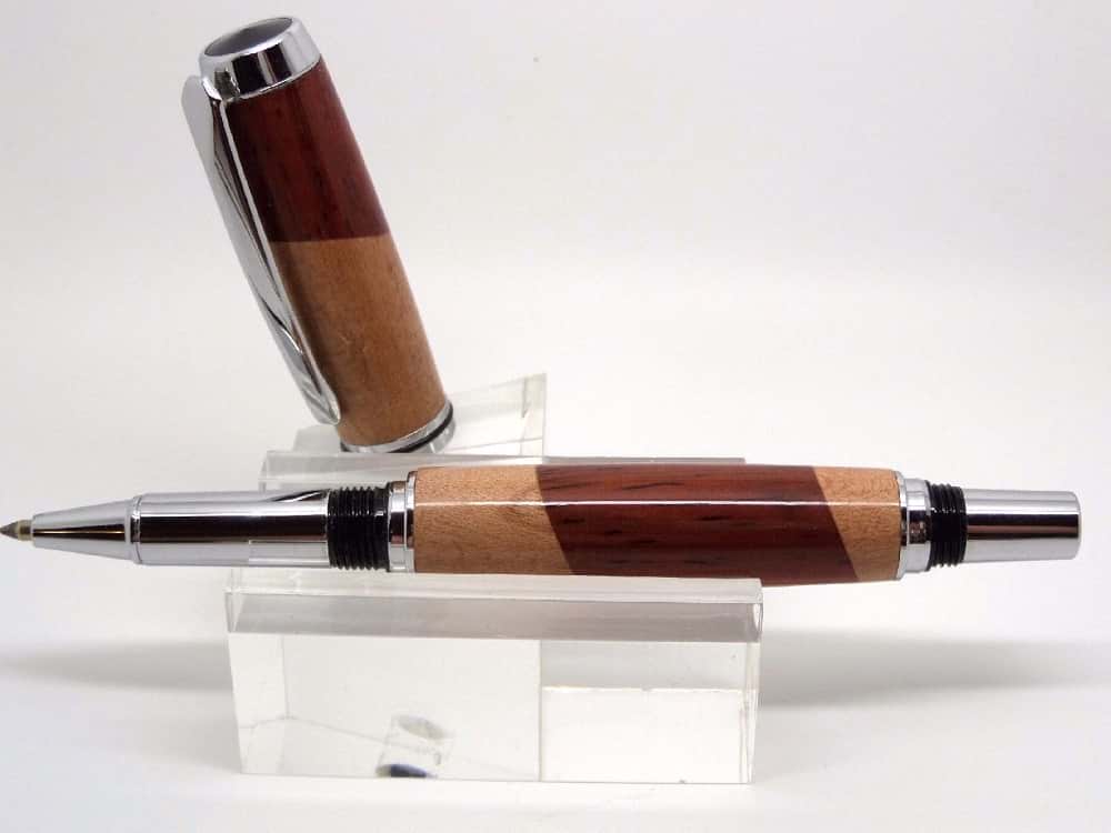Two tone segmented wooden rollerball pen on stand