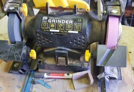 A 150 mm bench grinder with assorted jigs attached