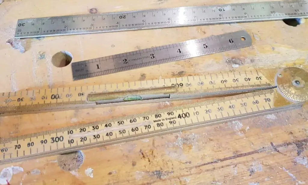 6 and 12 inch steel rulers and a folding rule